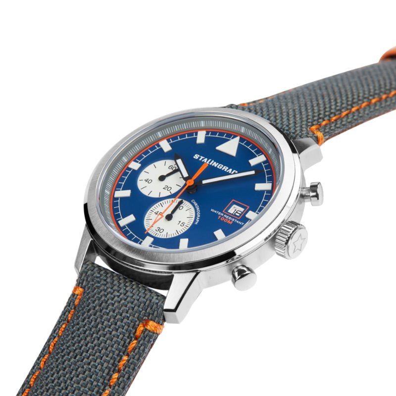 Stalingrad trooper chronograph watch with silver case, blue dial and grey Cordura straps with orange stitching, diagonal view on a white background 